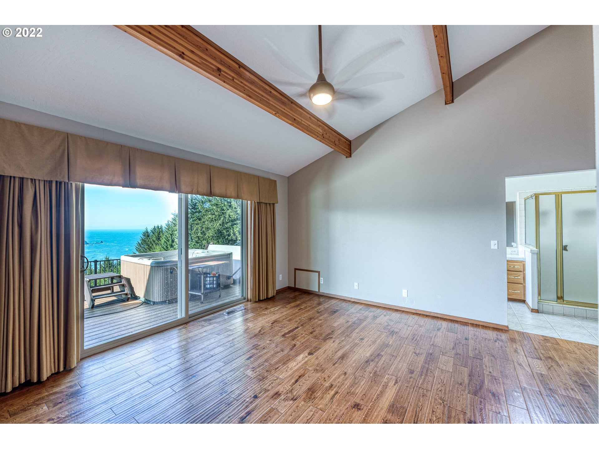 95525 West Huckleberry Ridge Road Brookings, OR 97415 - Photo 14 of 32 an empty room with wooden floor and outdoor view