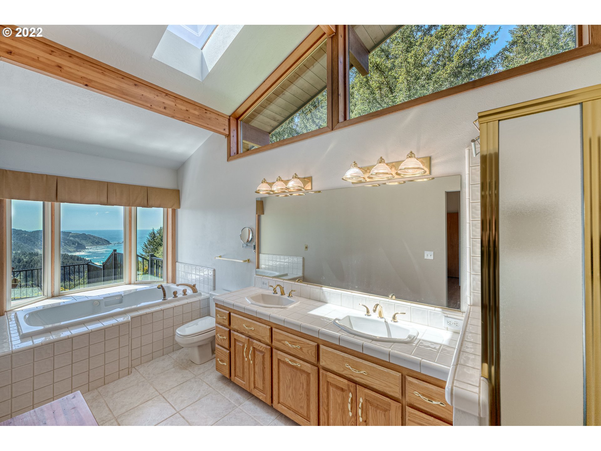 95525 West Huckleberry Ridge Road Brookings, OR 97415 - Photo 15 of 32 a bathroom with a sink mirror and a bathtub