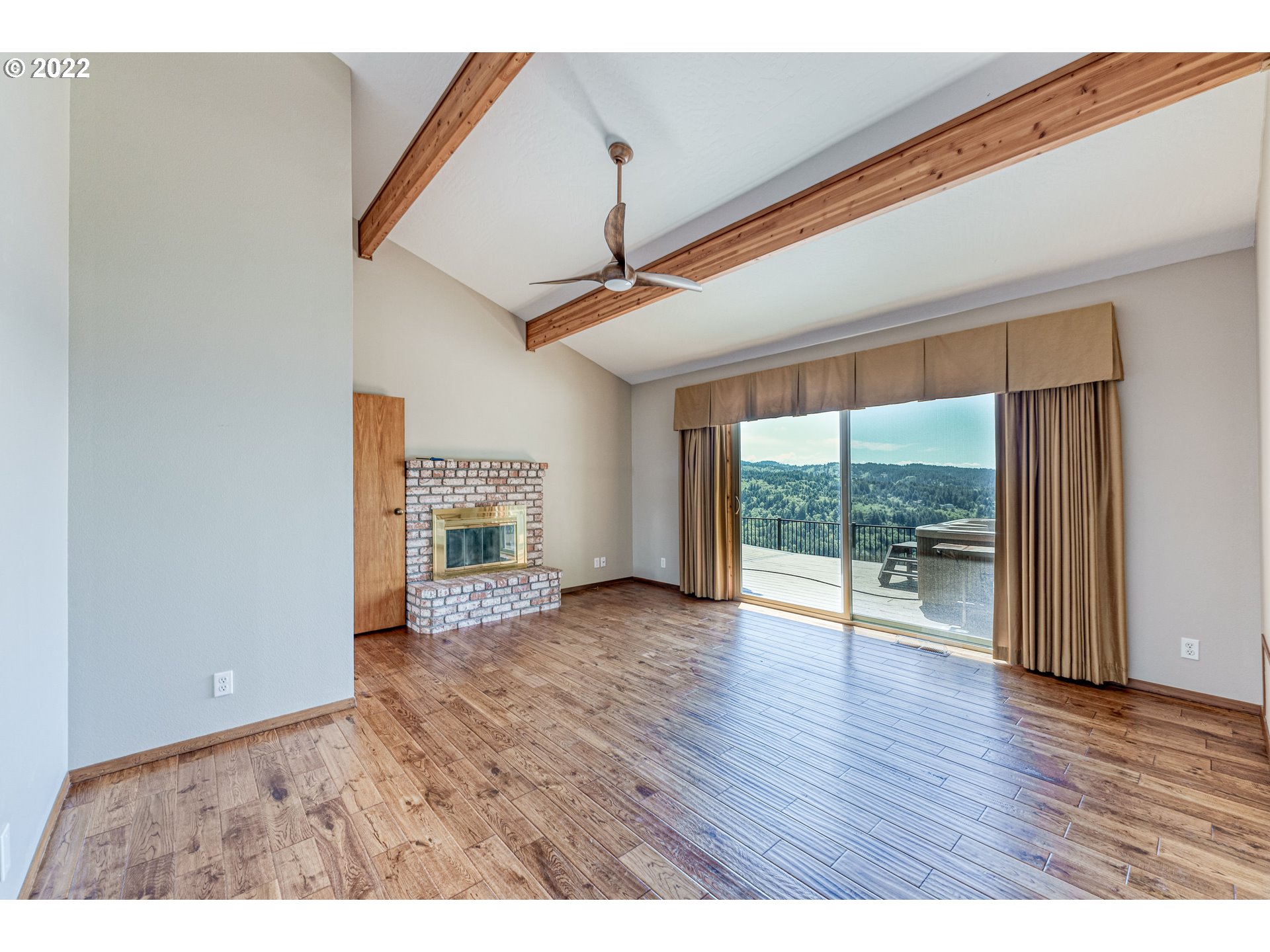95525 West Huckleberry Ridge Road Brookings, OR 97415 - Photo 17 of 32 an empty room with wooden floor and windows