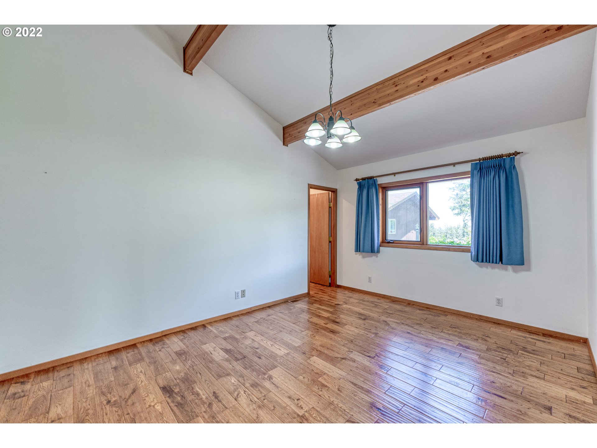 95525 West Huckleberry Ridge Road Brookings, OR 97415 - Photo 18 of 32 a view of an empty room with window and chandelier fan