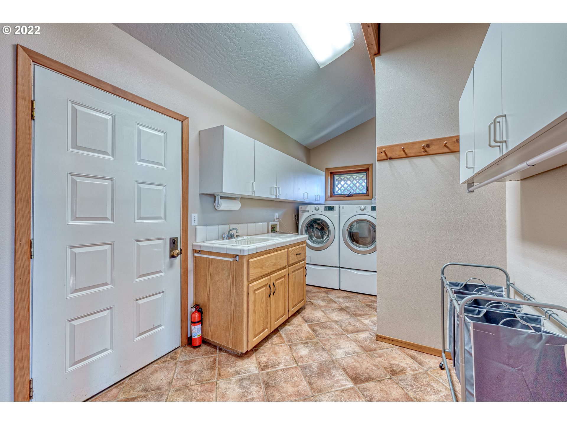 95525 West Huckleberry Ridge Road Brookings, OR 97415 - Photo 20 of 32 a kitchen with cabinets and white appliances
