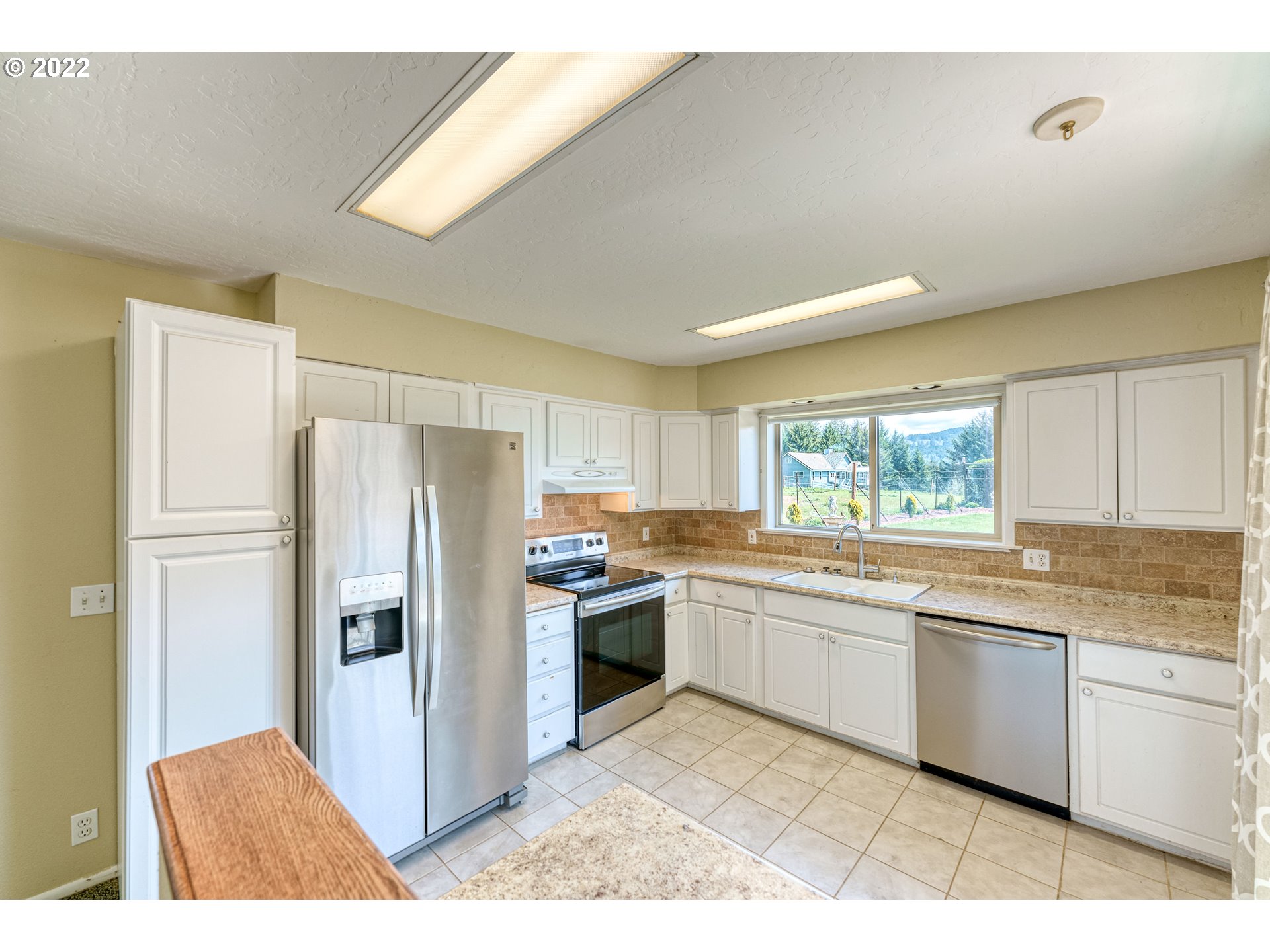95525 West Huckleberry Ridge Road Brookings, OR 97415 - Photo 24 of 32 a kitchen with stainless steel appliances granite countertop a refrigerator and a sink