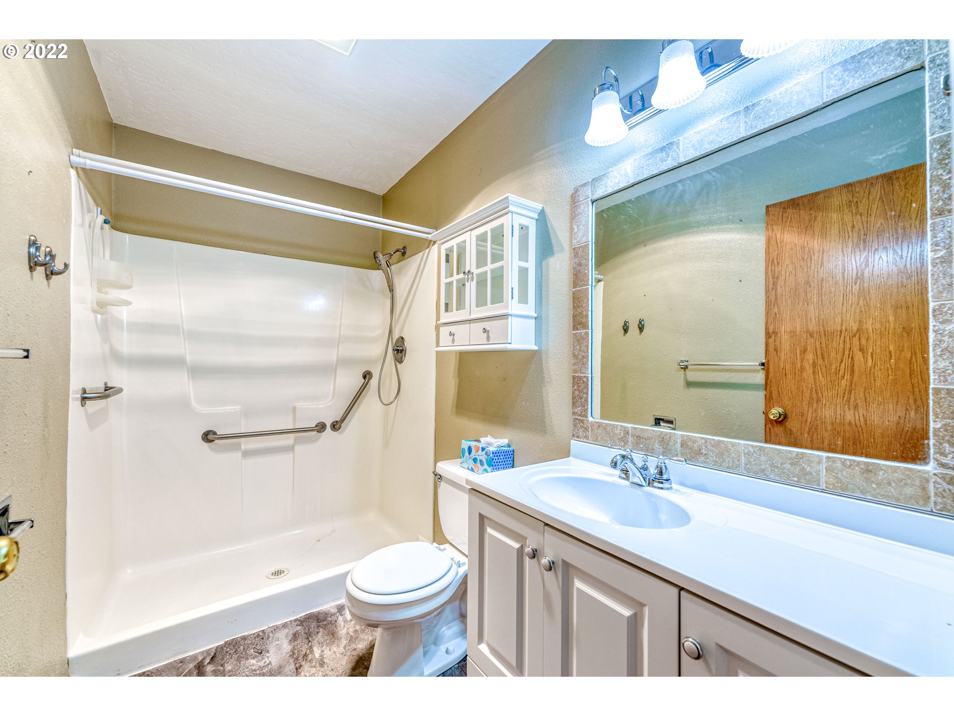 95525 West Huckleberry Ridge Road Brookings, OR 97415 - Photo 26 of 32 a bathroom with a sink a toilet a mirror and shower