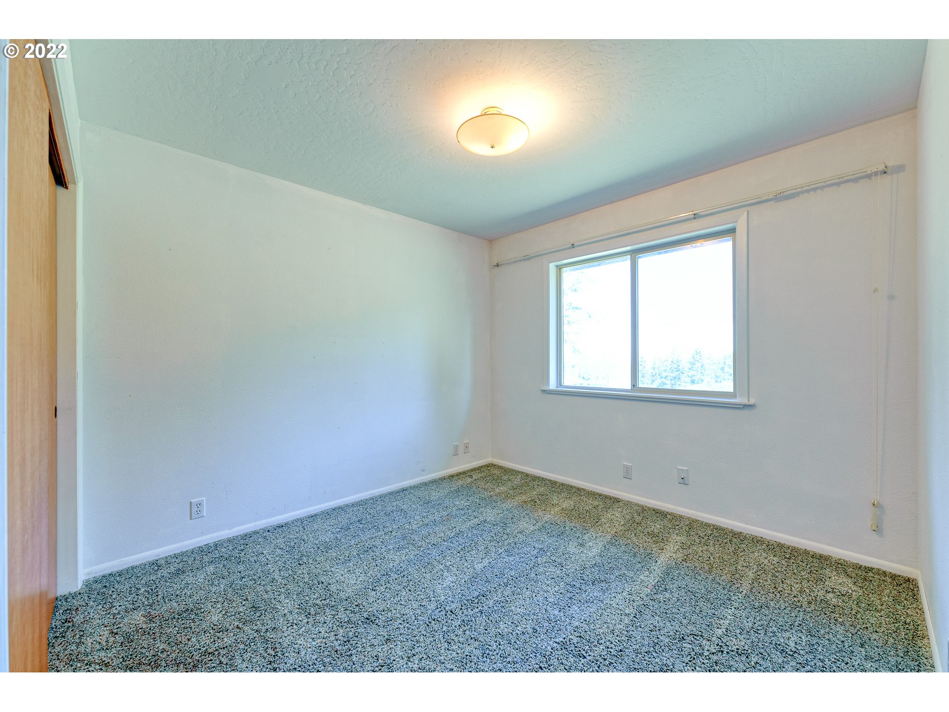 95525 West Huckleberry Ridge Road Brookings, OR 97415 - Photo 27 of 32 a view of an empty room and window