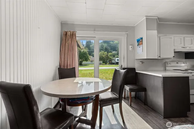 a view of a dining room with furniture and a window