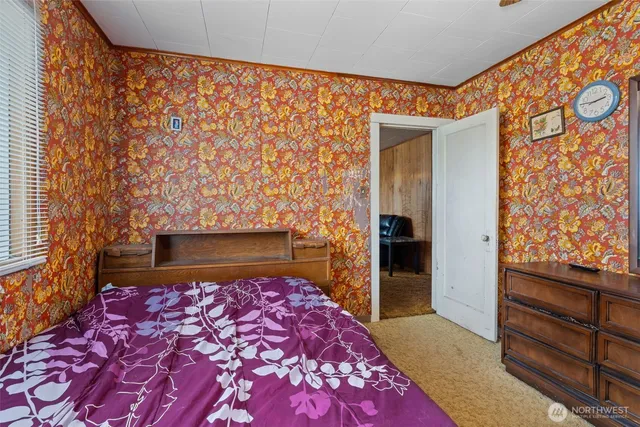 a bedroom with a bed and a dresser