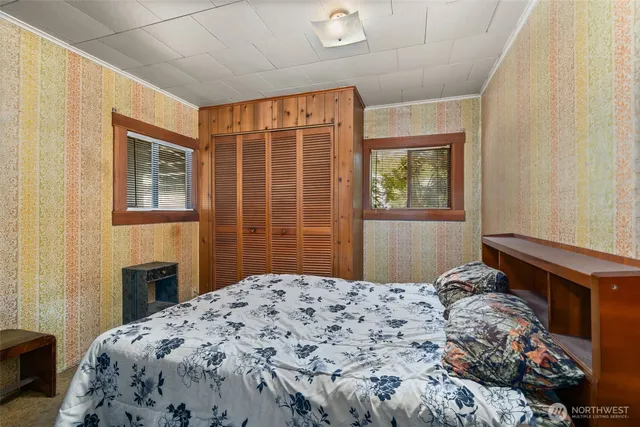 a bedroom with a bed and a window