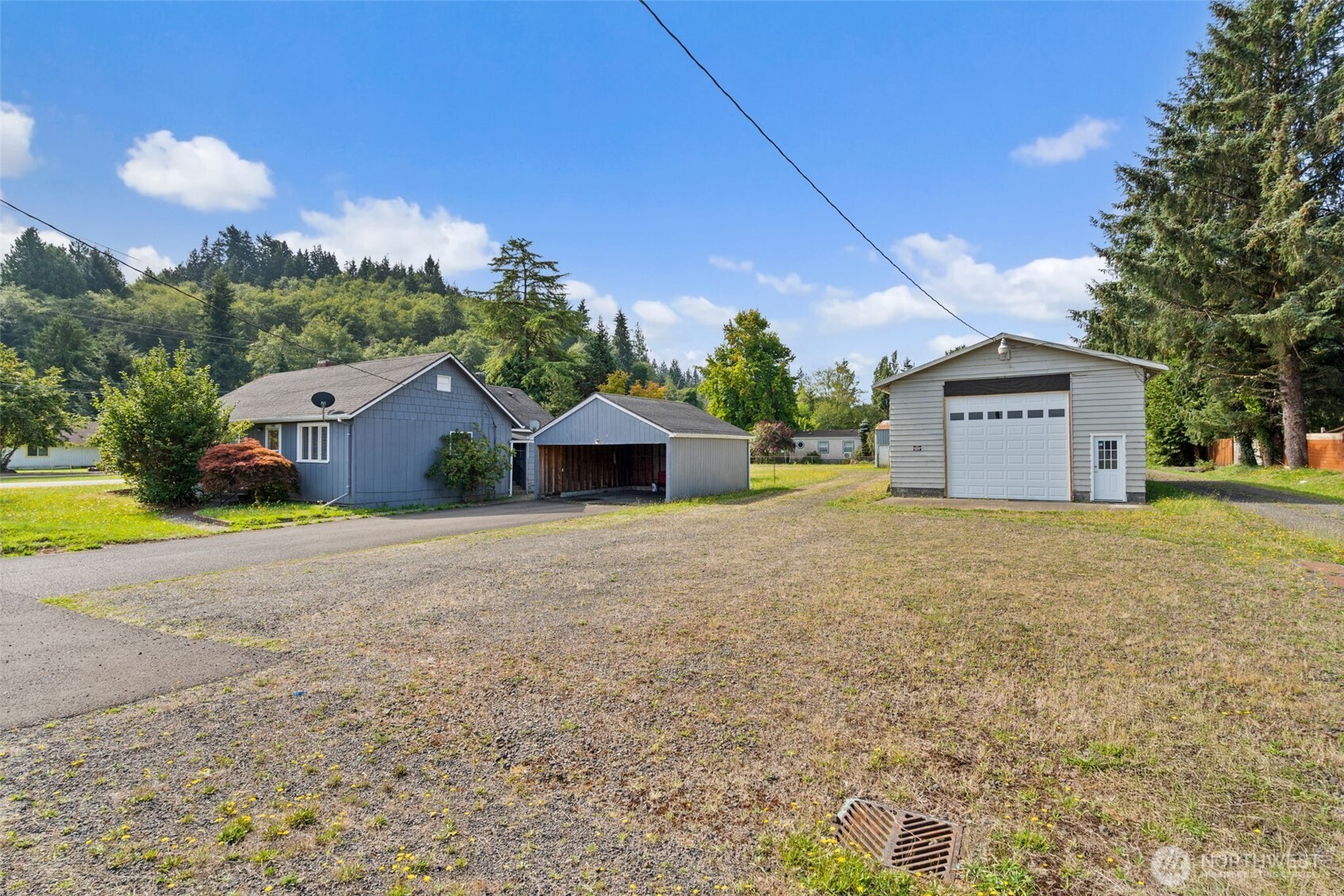 1206 West 4th Street South Bend, WA 98586 - Photo 2 of 29 a front view of a house with a yard and garage