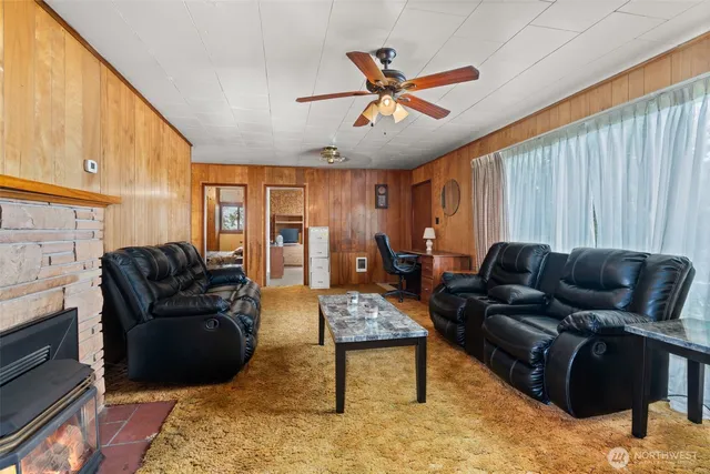 a living room with furniture ceiling fan and a rug