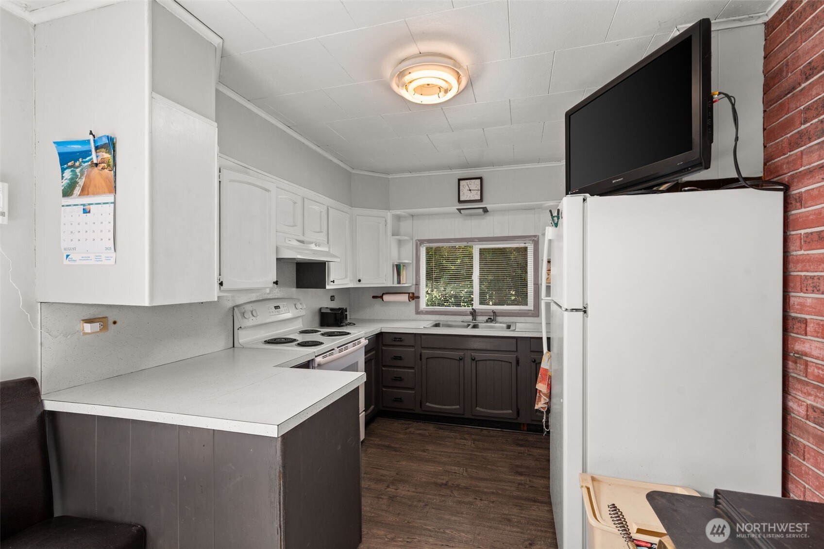 1206 West 4th Street South Bend, WA 98586 - Photo 8 of 29 a kitchen with a sink a stove and microwave