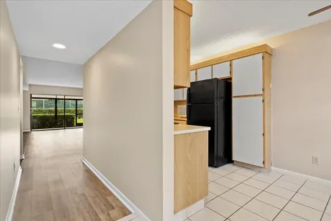 a view of hallway with furniture and a refrigerator