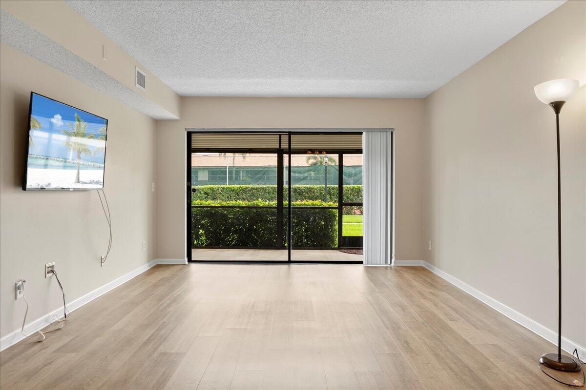 301 Pinecrest Circle, Unit C Jupiter, FL 33458 - Photo 10 of 36 Living Room with Patio Access