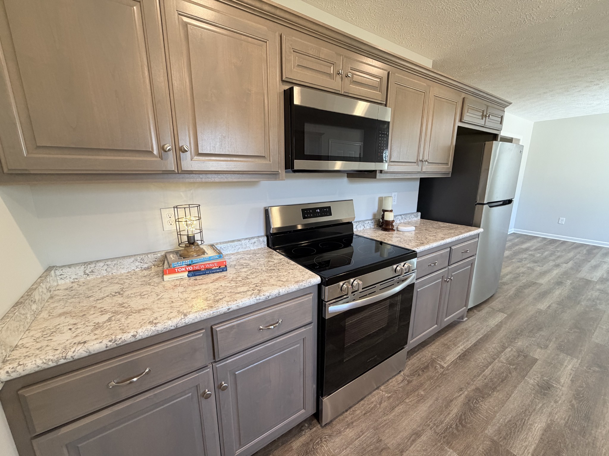 74 6 Mile Board Road Winchester, TN 37398 - Photo 30 of 99 a kitchen with stainless steel appliances granite countertop a sink a stove a microwave and refrigerator