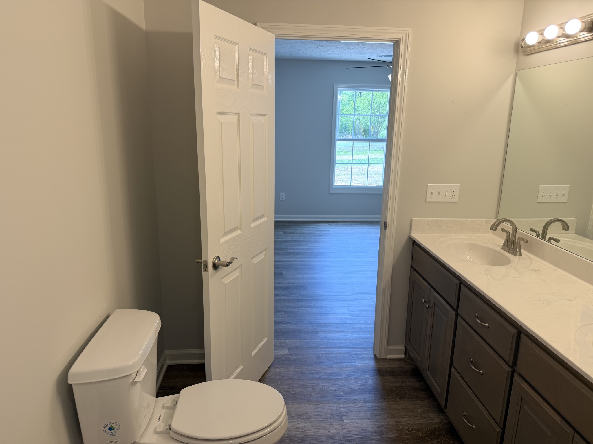 74 6 Mile Board Road Winchester, TN 37398 - Photo 37 of 99 a bathroom with a granite countertop toilet a sink and a mirror