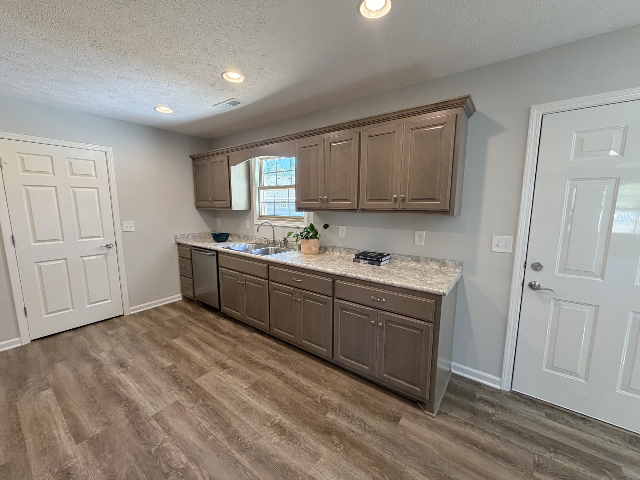 74 6 Mile Board Road Winchester, TN 37398 - Photo 41 of 99 a kitchen with a sink cabinets and wooden floor