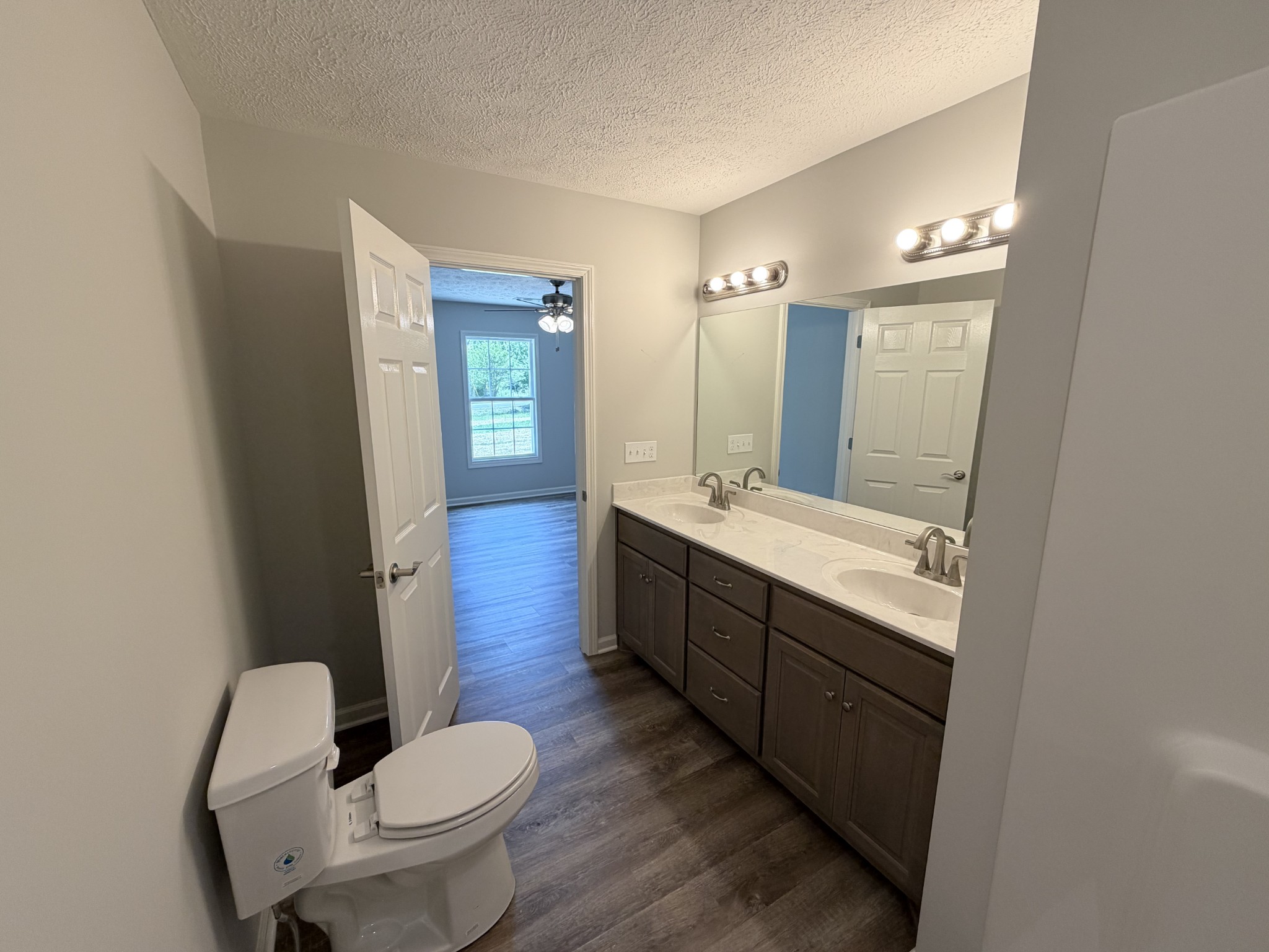 74 6 Mile Board Road Winchester, TN 37398 - Photo 43 of 99 a bathroom with a toilet sink double vanity and mirror