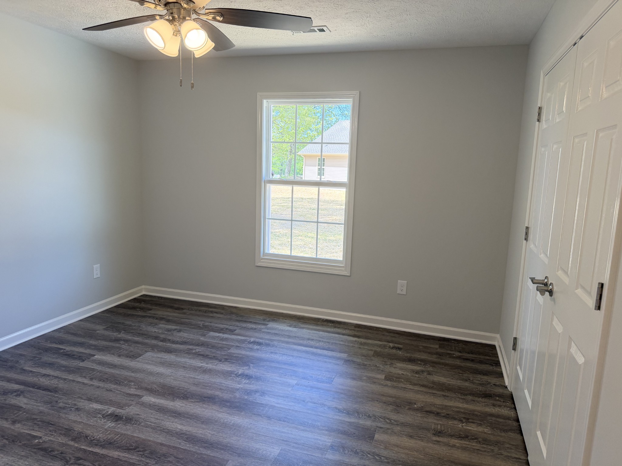 74 6 Mile Board Road Winchester, TN 37398 - Photo 51 of 99 a view of an empty room with wooden floor and a window