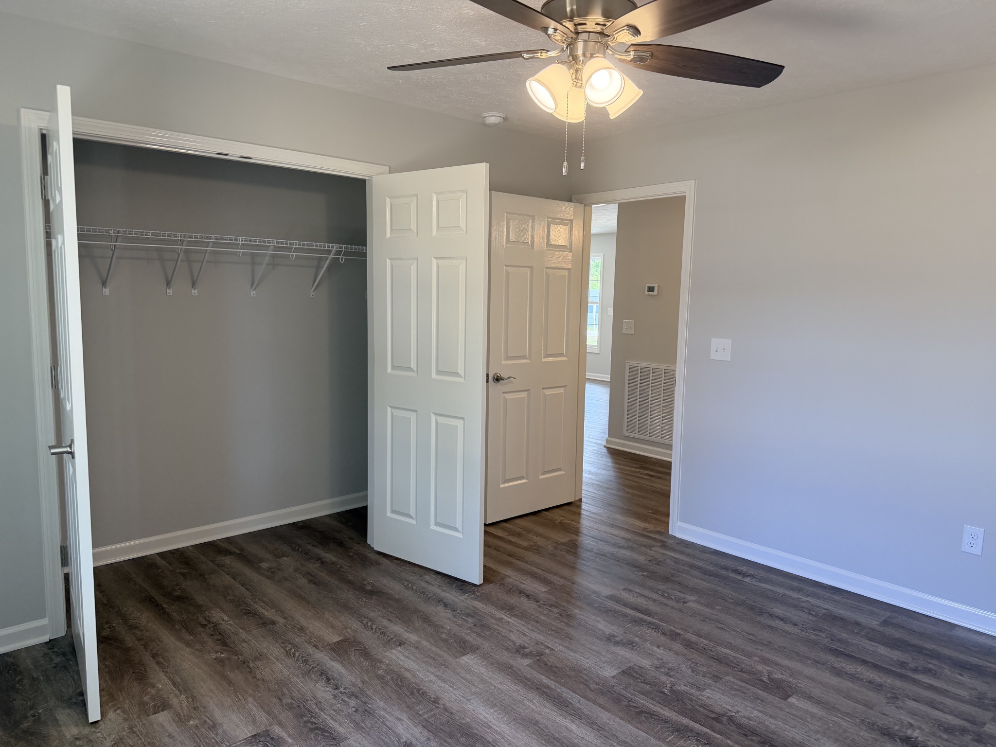 74 6 Mile Board Road Winchester, TN 37398 - Photo 57 of 99 an empty room with wooden floor fan and windows