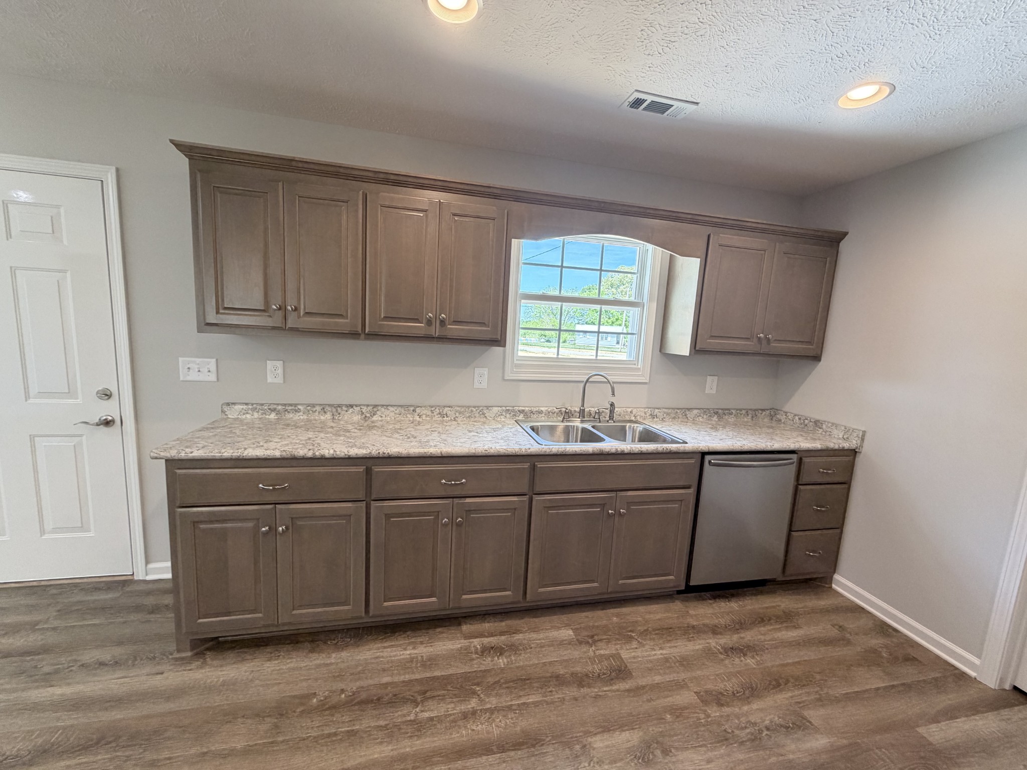 74 6 Mile Board Road Winchester, TN 37398 - Photo 79 of 99 a kitchen with granite countertop a sink cabinets and wooden floor