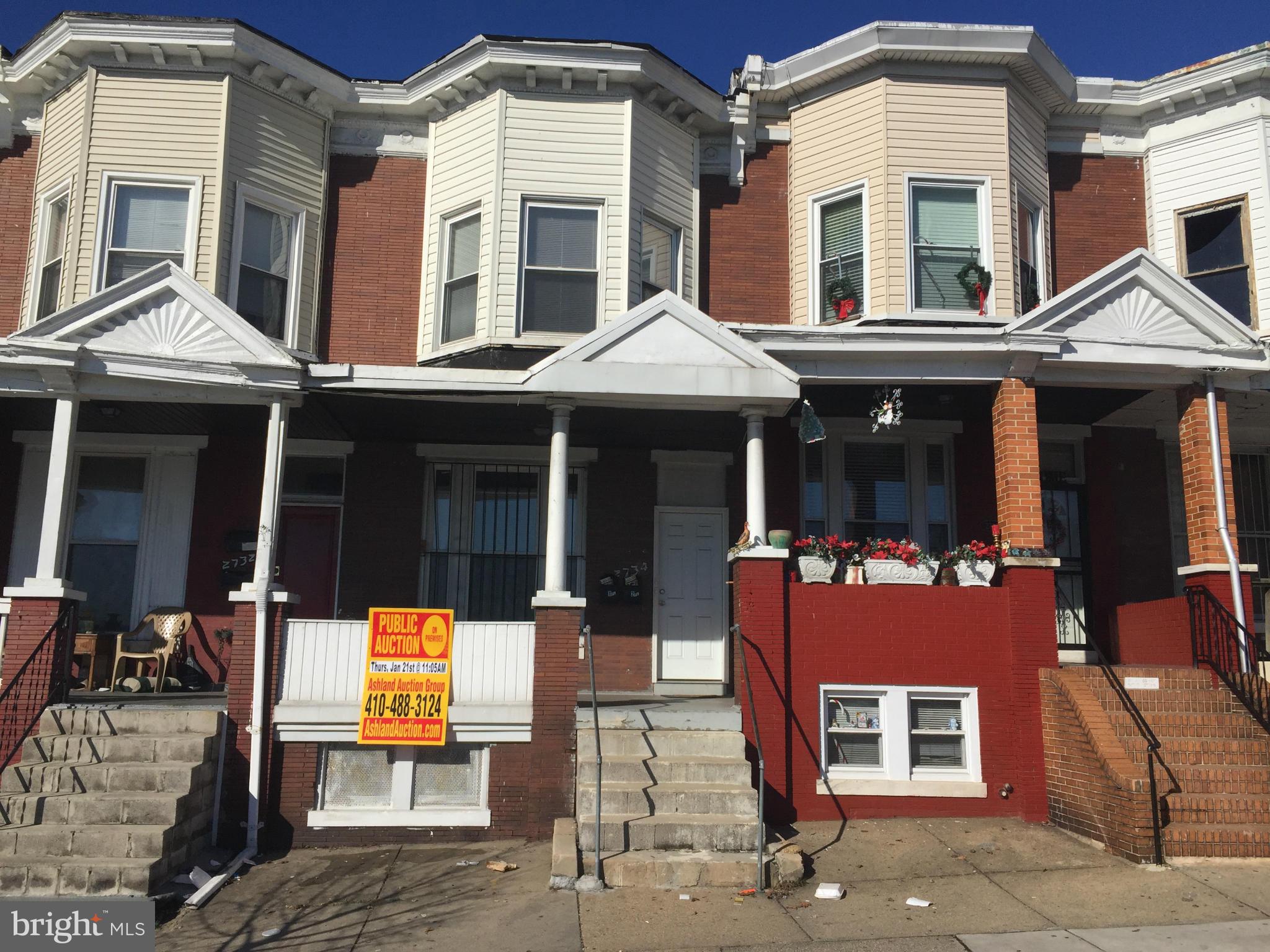 2734 Harford Road Baltimore, MD 21218 - Photo 1 of 12 a front view of a residential apartment building with a yard