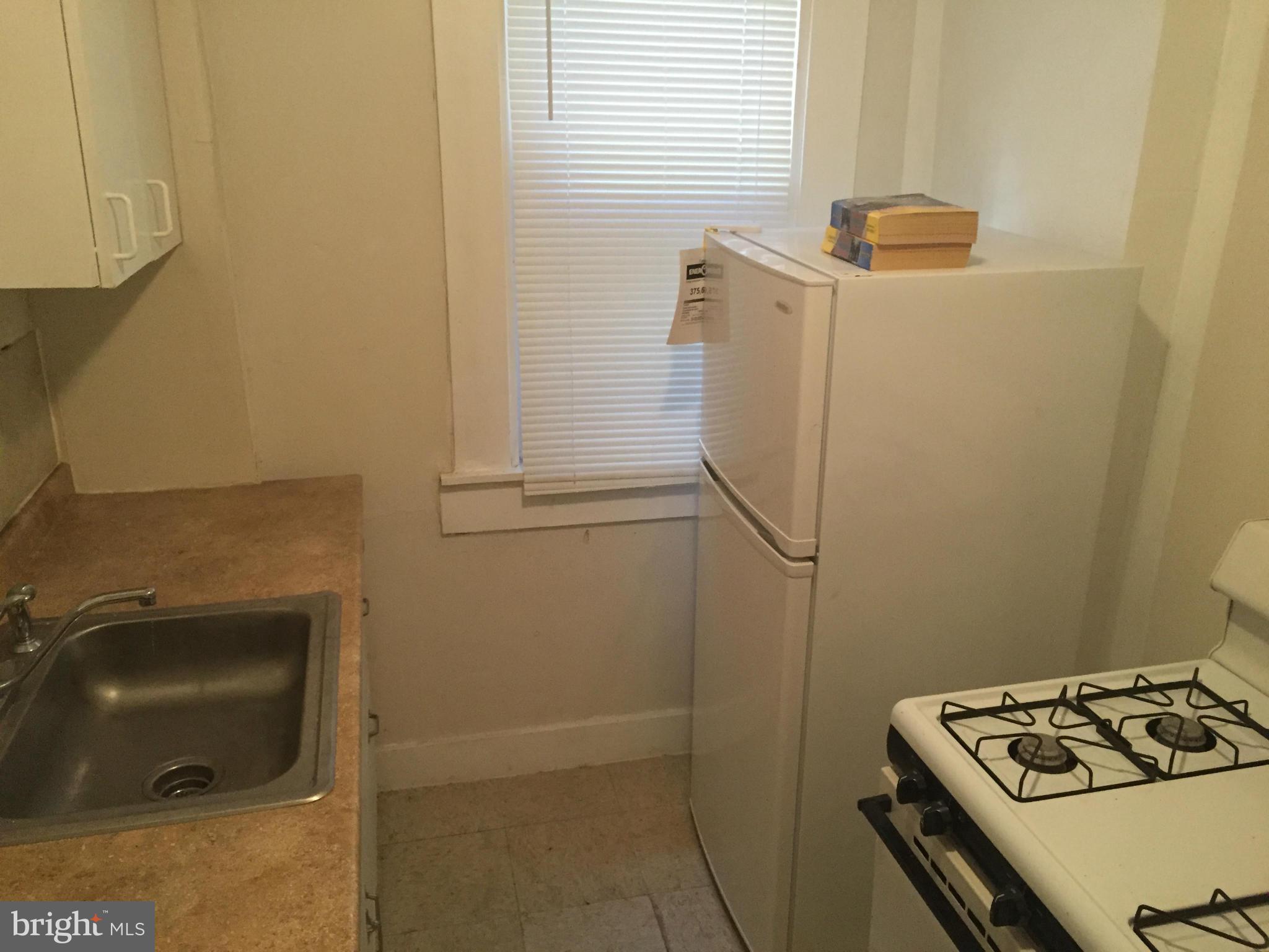 2734 Harford Road Baltimore, MD 21218 - Photo 4 of 12 a bathroom with a sink and a washing machine