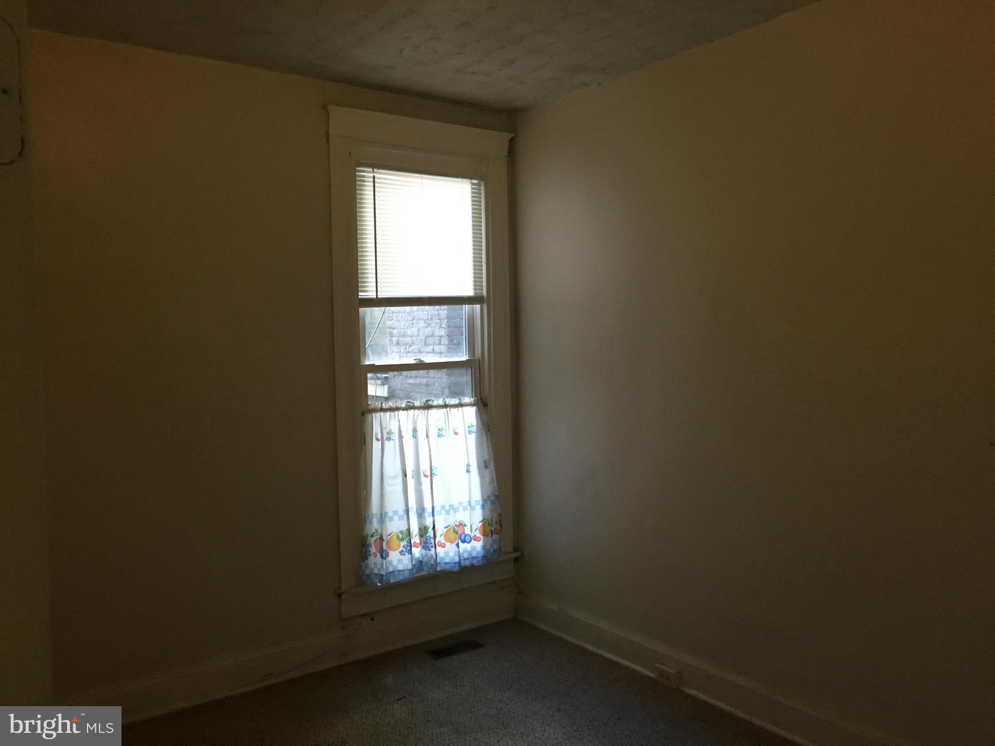 2734 Harford Road Baltimore, MD 21218 - Photo 5 of 12 a view of an empty room and a window