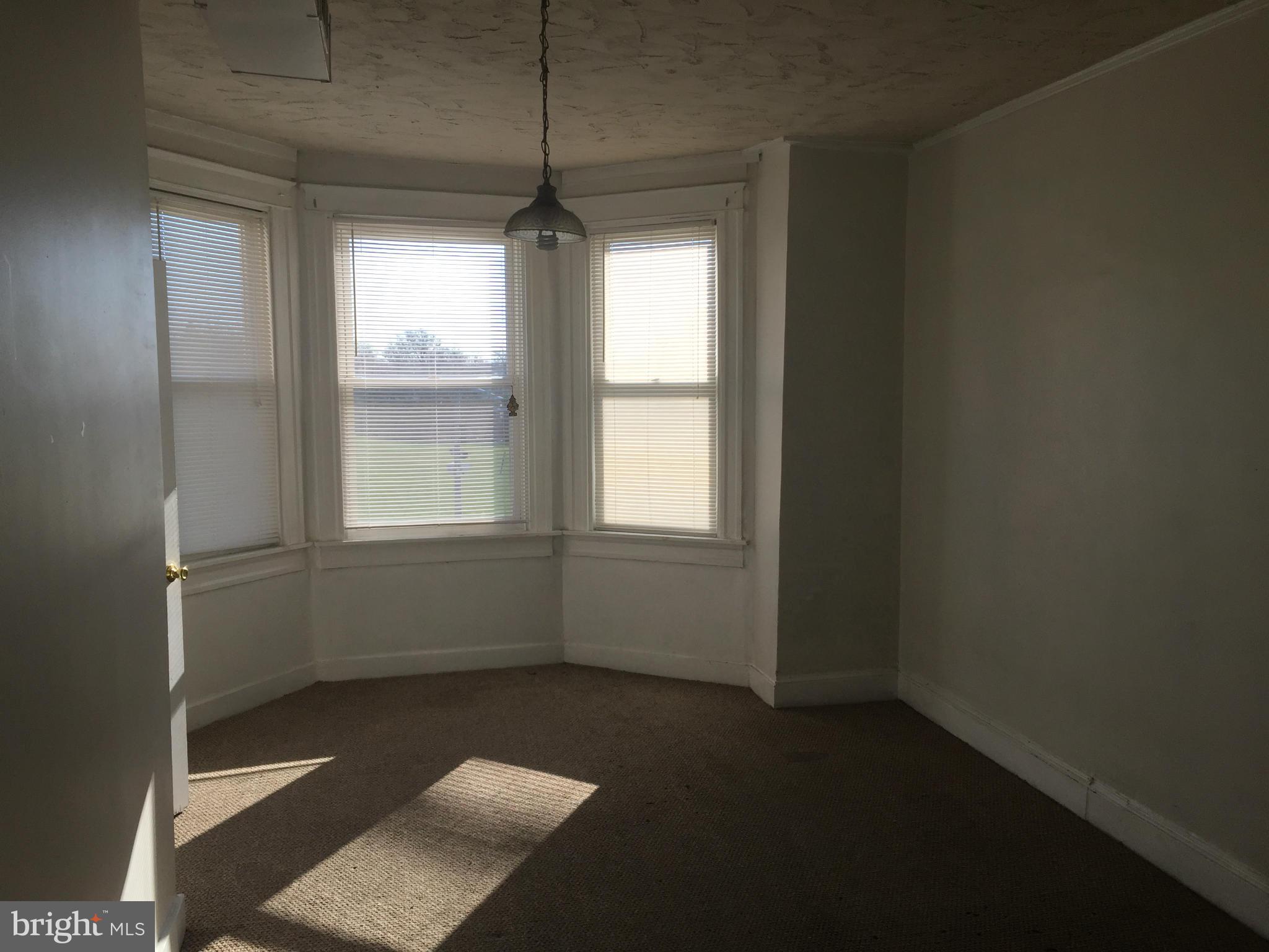 2734 Harford Road Baltimore, MD 21218 - Photo 8 of 12 a view of an empty room with a window