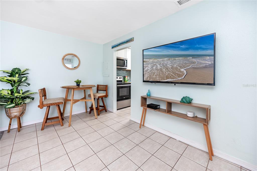 159 Medallion Boulevard, Unit H Madeira Beach, FL 33708 - Photo 11 of 57 a room with furniture and a potted plant