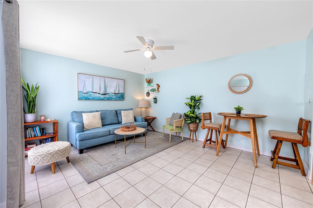 159 Medallion Boulevard, Unit H Madeira Beach, FL 33708 - Photo 12 of 57 a living room with furniture and a rug