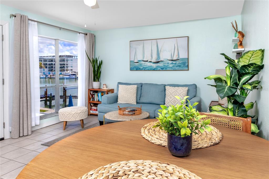 159 Medallion Boulevard, Unit H Madeira Beach, FL 33708 - Photo 15 of 57 a living room with furniture and a potted plant