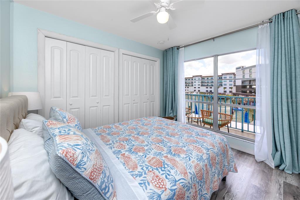 159 Medallion Boulevard, Unit H Madeira Beach, FL 33708 - Photo 21 of 57 a bedroom with a large bed and a large window