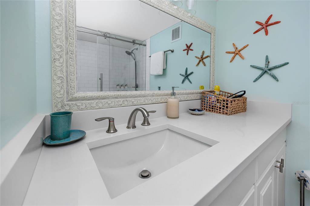 159 Medallion Boulevard, Unit H Madeira Beach, FL 33708 - Photo 26 of 57 a bathroom with a sink and a mirror