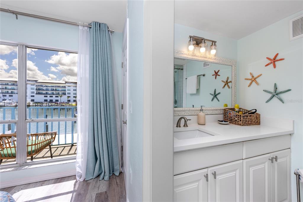 159 Medallion Boulevard, Unit H Madeira Beach, FL 33708 - Photo 30 of 57 a bathroom with a sink and a mirror