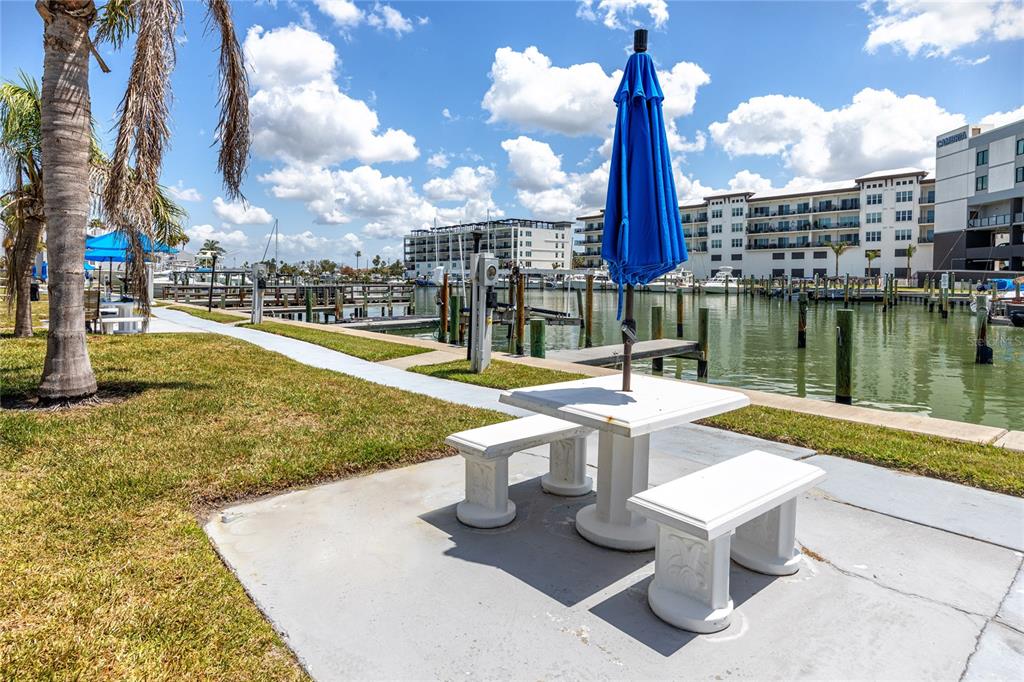 159 Medallion Boulevard, Unit H Madeira Beach, FL 33708 - Photo 37 of 57 a view of a patio with a table and chairs