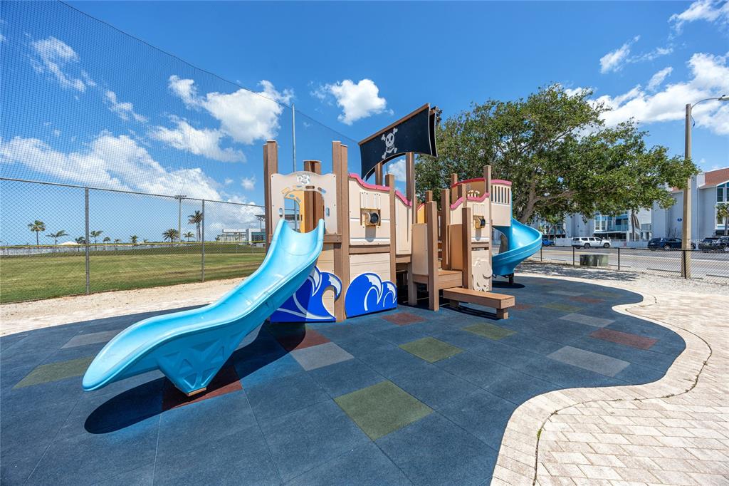 159 Medallion Boulevard, Unit H Madeira Beach, FL 33708 - Photo 40 of 57 a view of a park with slide
