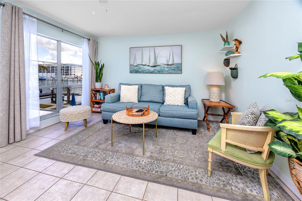 159 Medallion Boulevard, Unit H Madeira Beach, FL 33708 - Photo 8 of 57 a living room with furniture and a potted plant