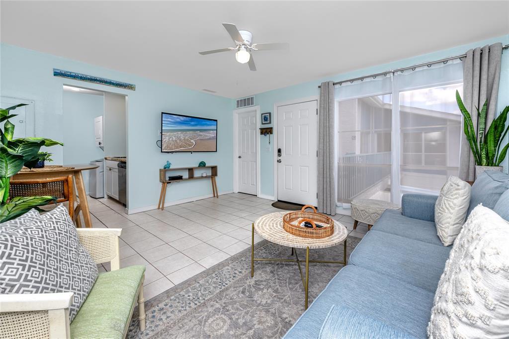 159 Medallion Boulevard, Unit H Madeira Beach, FL 33708 - Photo 9 of 57 a living room with furniture and a table
