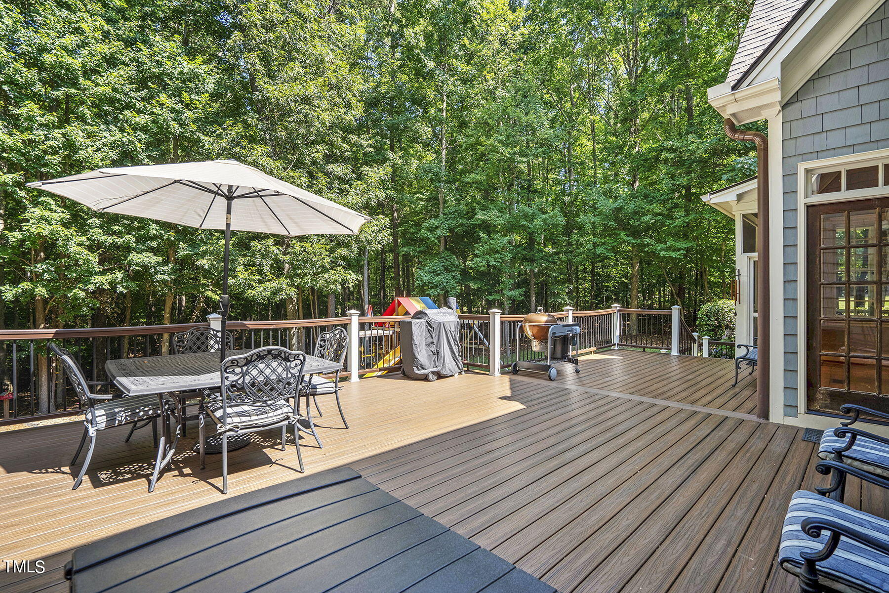 1016 Quiet Ridge Circle Raleigh, NC 27614 - Photo 27 of 31 a view of a roof deck with table and chairs under an umbrella with wooden floor