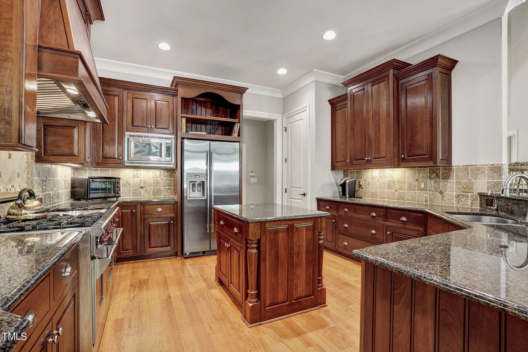 1016 Quiet Ridge Circle Raleigh, NC 27614 - Photo 9 of 31 a kitchen with stainless steel appliances granite countertop a stove top oven a sink dishwasher a refrigerator and cabinets with wooden floor