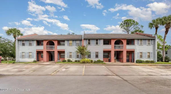 a front view of residential houses with yard