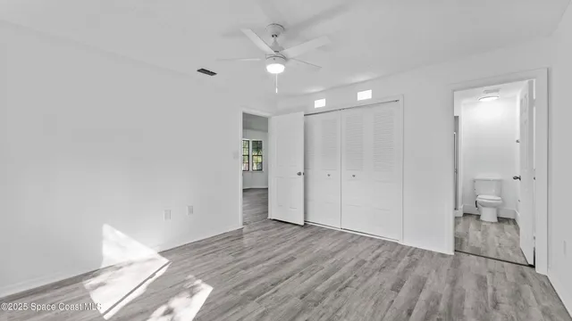 a view of an empty room and a bathroom