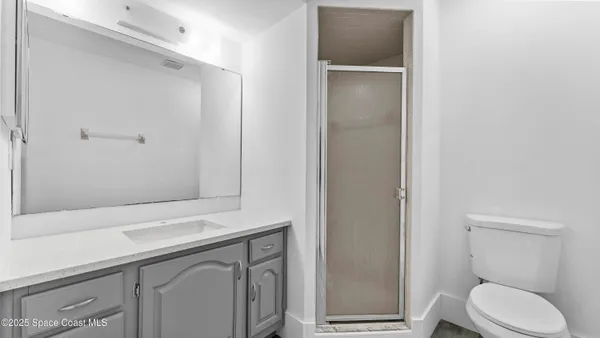 a bathroom with a toilet sink and vanity