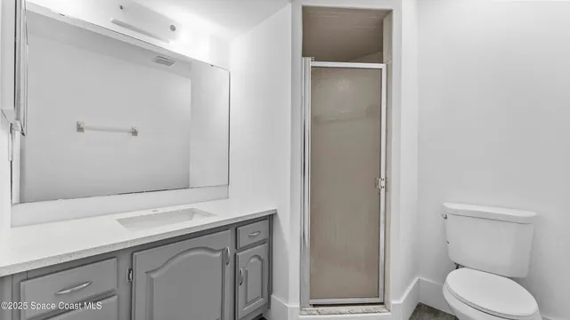 a bathroom with a toilet sink and vanity