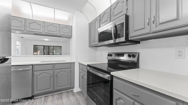 a kitchen with stainless steel appliances granite countertop a sink and a stove