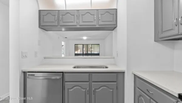 a kitchen with cabinets and a stove