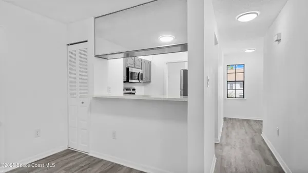 a view of a hallway with wooden floor