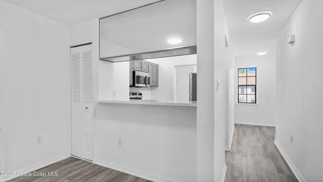 a view of a hallway with wooden floor