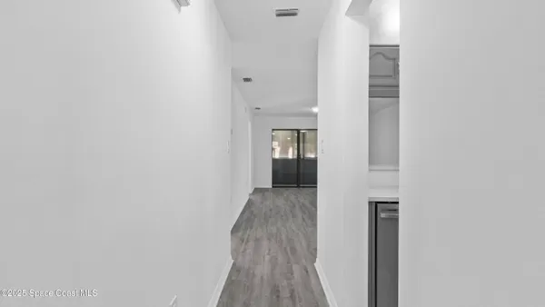 a view of hallway with wooden floor