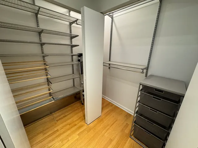 a view of walk in closet with empty racks