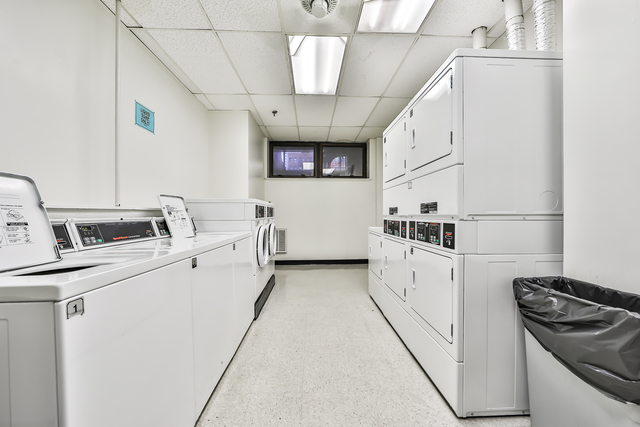 680 South Federal Street, Unit 903 Chicago, IL 60605 - Photo 20 of 27 a kitchen with white cabinets and white appliances